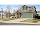 Charming two-story home featuring green siding, a covered front porch, and an attached two-car garage at 11207 Day Star Ct, Parker, CO 80138