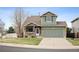 Charming two-story home with a well-manicured lawn and inviting front porch and two-car garage at 11207 Day Star Ct, Parker, CO 80138