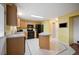 Kitchen featuring wood cabinets, an island, and black appliances at 11207 Day Star Ct, Parker, CO 80138
