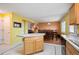 Open kitchen with a center island that flows into an eating area and living room at 11207 Day Star Ct, Parker, CO 80138