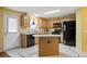 Functional kitchen with wood cabinets, modern appliances, and a convenient center island at 11207 Day Star Ct, Parker, CO 80138