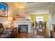 Inviting living room with a fireplace, hardwood floors, and an open view to the dining area at 11207 Day Star Ct, Parker, CO 80138
