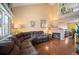 Spacious living room featuring a cozy fireplace, hardwood floors, and ample natural light at 11207 Day Star Ct, Parker, CO 80138