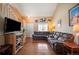 Comfortable living room featuring a large sectional sofa and hardwood floors with easy access to the stairway at 11207 Day Star Ct, Parker, CO 80138