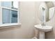 Bathroom featuring a pedestal sink, white fixtures, and a window at 19019 E 94Th Pl, Commerce City, CO 80022