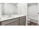 Bathroom featuring single sink with white quartz countertop and grey cabinets at 19019 E 94Th Pl, Commerce City, CO 80022
