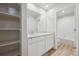 Bright bathroom featuring single vanity, shelves, and combined shower and tub at 19019 E 94Th Pl, Commerce City, CO 80022