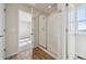 Bathroom featuring a clear glass shower enclosure, wood look flooring, and an open doorway at 19019 E 94Th Pl, Commerce City, CO 80022