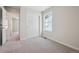 Bedroom featuring neutral carpet, base trim, white doors and a bright window at 19019 E 94Th Pl, Commerce City, CO 80022