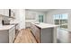Modern kitchen featuring stainless appliances, light grey cabinets and a center island at 19019 E 94Th Pl, Commerce City, CO 80022