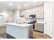 Modern kitchen features an island, stainless steel appliances, and ample cabinet space, perfect for cooking at 19019 E 94Th Pl, Commerce City, CO 80022