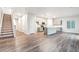 Open-concept living space with modern kitchen, island, stainless appliances, and stylish staircase at 19019 E 94Th Pl, Commerce City, CO 80022