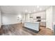 Open-concept living space with kitchen island and modern appliances at 19019 E 94Th Pl, Commerce City, CO 80022