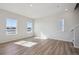 Open living room featuring wood-look flooring, modern windows and natural lighting at 19019 E 94Th Pl, Commerce City, CO 80022