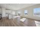 Open living room featuring wood-look flooring, modern windows and natural lighting at 19019 E 94Th Pl, Commerce City, CO 80022