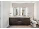 Modern bathroom with a double vanity, illuminated mirrors, and a separate toilet area at 4200 W 17Th Ave # 327, Denver, CO 80204