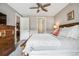 Bedroom showing neutral walls, wooden furniture, and open doorways to the kitchen and bathroom at 4200 W 17Th Ave # 327, Denver, CO 80204