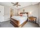 Comfortable bedroom with a ceiling fan, wooden furnishings, and neutral walls at 4200 W 17Th Ave # 327, Denver, CO 80204