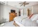 Bedroom showing a dresser, ceiling fan, and doorways leading to the kitchen and bathroom at 4200 W 17Th Ave # 327, Denver, CO 80204