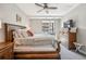 Bedroom featuring a ceiling fan, wood furnishings, and a window overlooking a neighborhood at 4200 W 17Th Ave # 327, Denver, CO 80204