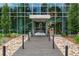 Lakehouse building entrance with stone landscape, pavers, and glass facade creating an inviting entryway at 4200 W 17Th Ave # 327, Denver, CO 80204