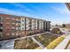 Modern apartment building with manicured lawn and walkway on a sunny day at 4200 W 17Th Ave # 327, Denver, CO 80204