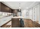 Spacious kitchen with stainless steel appliances, marble countertops, a gas range, island, and wood floors at 4200 W 17Th Ave # 327, Denver, CO 80204