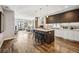 Open concept kitchen and living room with hardwood floors and modern finishes at 4200 W 17Th Ave # 327, Denver, CO 80204