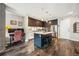 Modern kitchen with dark wood cabinets, white backsplash, and stainless steel appliances at 4200 W 17Th Ave # 327, Denver, CO 80204