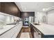 Sleek kitchen with stainless steel appliances, gas range, dark cabinets, marble countertops, and wood floors at 4200 W 17Th Ave # 327, Denver, CO 80204