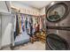 Well-organized walk-in closet with built-in shelves and hanging racks, plus a washer and dryer at 4200 W 17Th Ave # 327, Denver, CO 80204