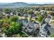 Aerial view of a home showcasing its prime location with mountain views, lush landscaping, and a well-manicured neighborhood at 14152 W Evans Cir, Lakewood, CO 80228