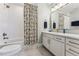 Stylish bathroom featuring a vanity with marble countertop and a shower-tub combo at 14152 W Evans Cir, Lakewood, CO 80228