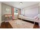 Charming bedroom with hardwood floors, area rug, and canopy bed, bathed in gentle light at 14152 W Evans Cir, Lakewood, CO 80228