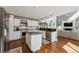 Open kitchen featuring an island, stainless steel appliances, granite countertops, and hardwood floors at 14152 W Evans Cir, Lakewood, CO 80228