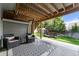 Relaxing covered patio space with comfortable seating, providing a cozy outdoor area for lounging and enjoying the backyard at 14152 W Evans Cir, Lakewood, CO 80228