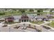 Aerial view of community center with well manicured lawn and landscaping, ample parking, and a pond at 5142 N Quemoy Ct, Aurora, CO 80019