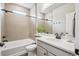 Bright bathroom featuring a tub, sleek tiling, quartz counters and modern fixtures at 5142 N Quemoy Ct, Aurora, CO 80019