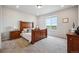 Spacious bedroom with large window, carpet, and dark wood furniture set at 5142 N Quemoy Ct, Aurora, CO 80019