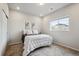 Cozy bedroom features neutral walls, soft carpet, and natural light from the window at 5142 N Quemoy Ct, Aurora, CO 80019