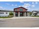 The building's exterior boasts a modern design with stone pillars, large windows, and professional landscaping at 5142 N Quemoy Ct, Aurora, CO 80019