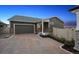 Charming single-story home featuring stone accents, a two-car garage, and a brick driveway at 5142 N Quemoy Ct, Aurora, CO 80019