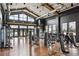 Bright gym with modern exercise equipment, high ceilings, and large windows overlooking the community at 5142 N Quemoy Ct, Aurora, CO 80019