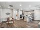 Modern kitchen with stainless steel appliances, granite countertops, and an open layout to the dining area at 5142 N Quemoy Ct, Aurora, CO 80019