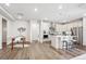 Open kitchen with white cabinets, stainless steel appliances, and a central island with bar seating at 5142 N Quemoy Ct, Aurora, CO 80019