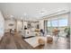 Open-concept living room with hardwood floors, large windows, and modern décor at 5142 N Quemoy Ct, Aurora, CO 80019