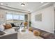 Bright living room with hardwood floors, a plush sofa, and a sliding glass door leading to outdoor space at 5142 N Quemoy Ct, Aurora, CO 80019