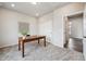 Office area featuring neutral walls, soft carpet, and natural light from the window at 5142 N Quemoy Ct, Aurora, CO 80019