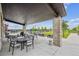 Outdoor patio with tables, chairs, and a view of the surrounding landscape, including a peek at the community pool at 5142 N Quemoy Ct, Aurora, CO 80019