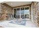 Covered patio boasts stone accents, outdoor seating, and a grill, perfect for entertaining at 5142 N Quemoy Ct, Aurora, CO 80019